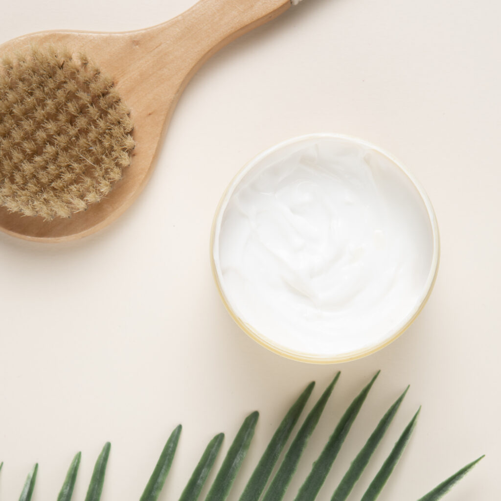 close up view body cream brush plain background
