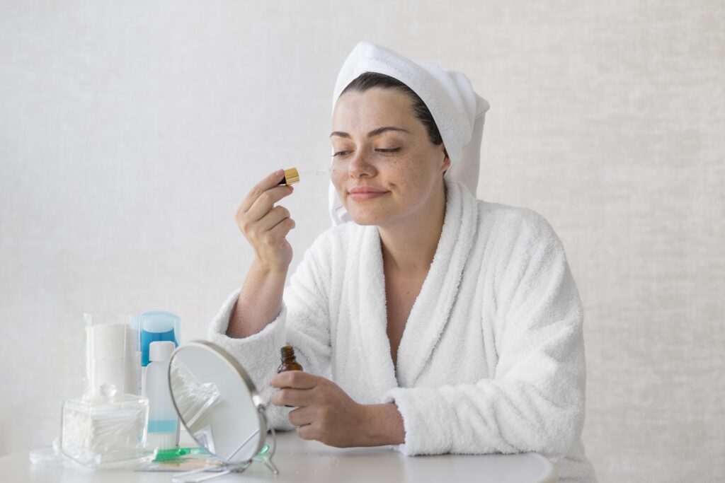 medium shot woman using serum
